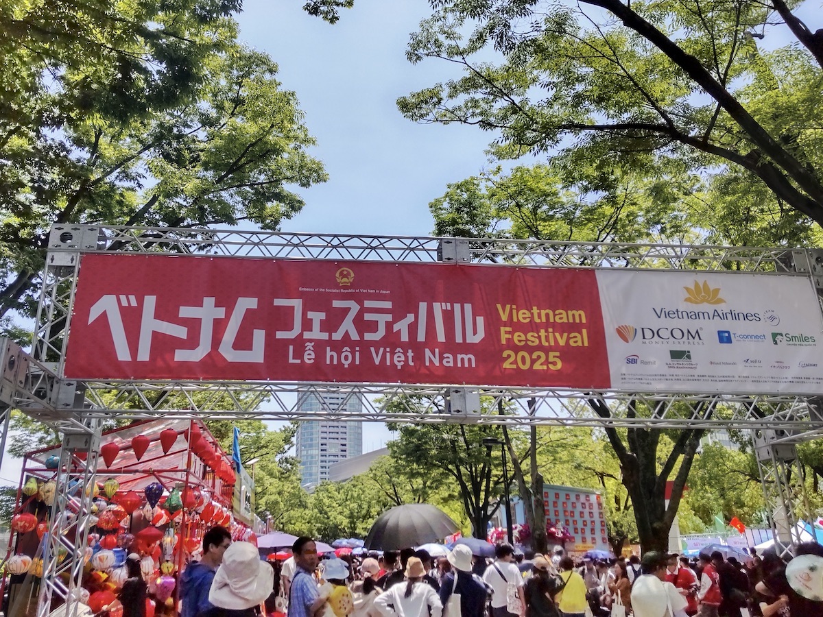 A red Vietnam Festival banner over a vibrant crowd in Yoyogi Park