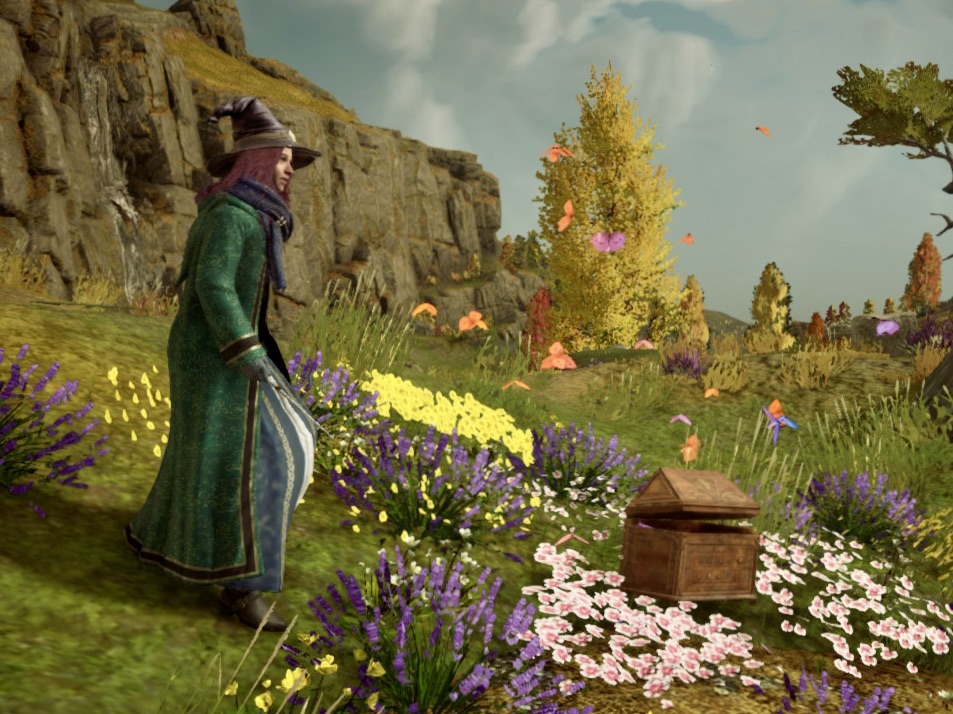 A brown-haired girl named Emily wearing a black leather witch hat, a green robe, and a blue dress in the world of Hogwarts Legacy.