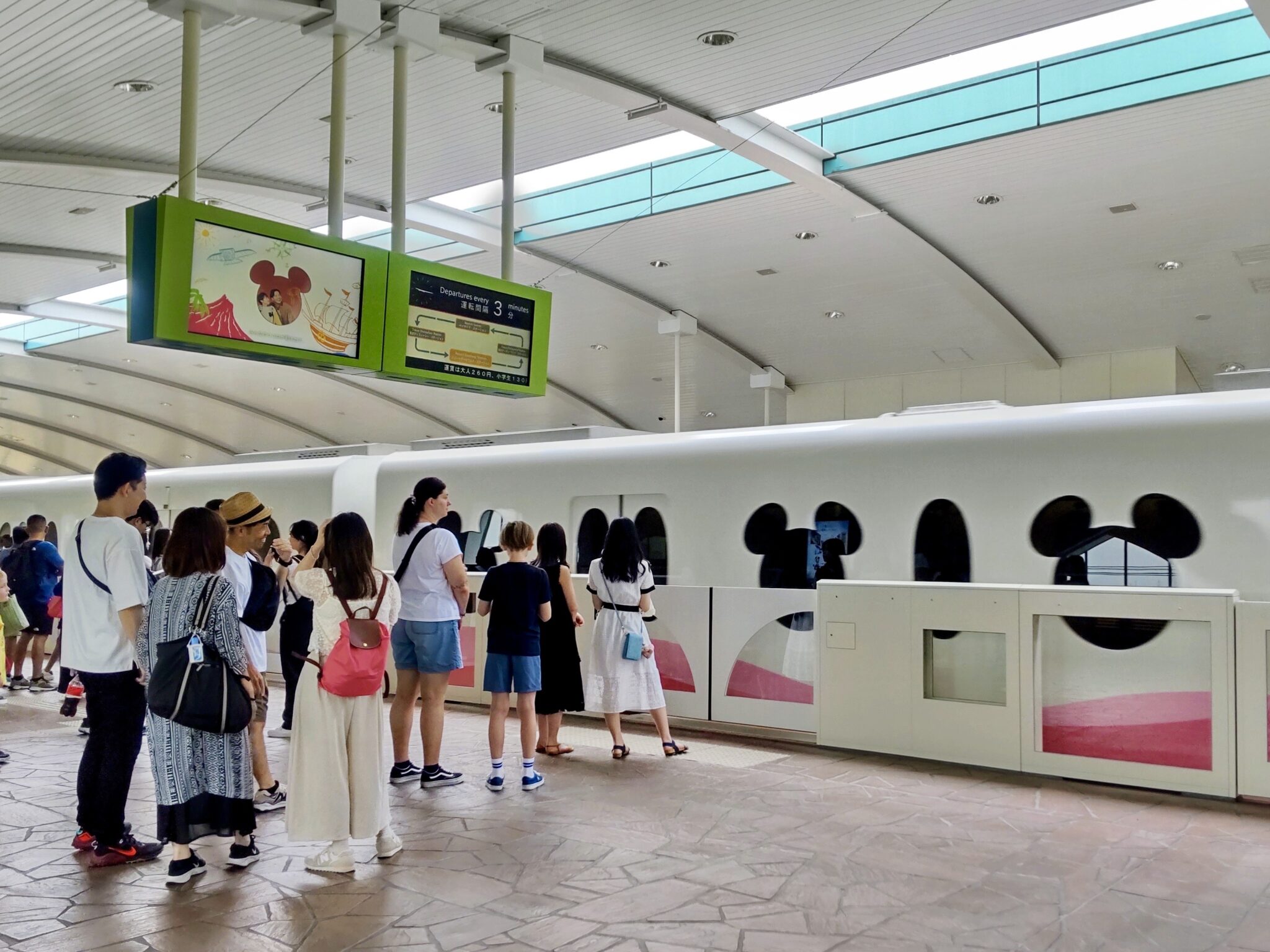 A Disney Resort Line monorail train arriving at the station platform
