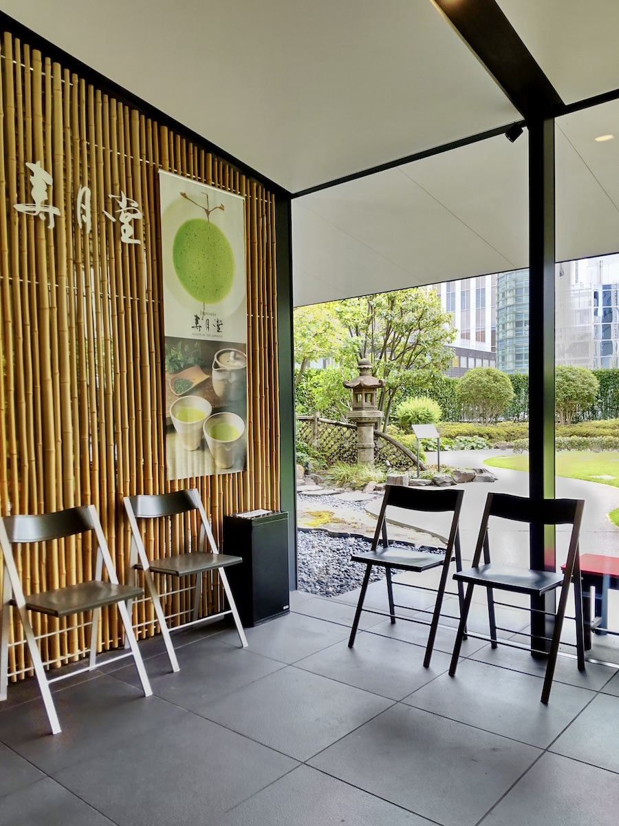 The entrance of a Japanese tea shop cafe where a peaceful garden is visible in the back
