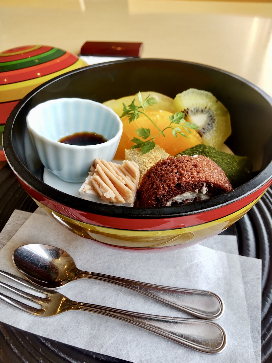 Cakes and fruits in a spherical Japanese-style vessel