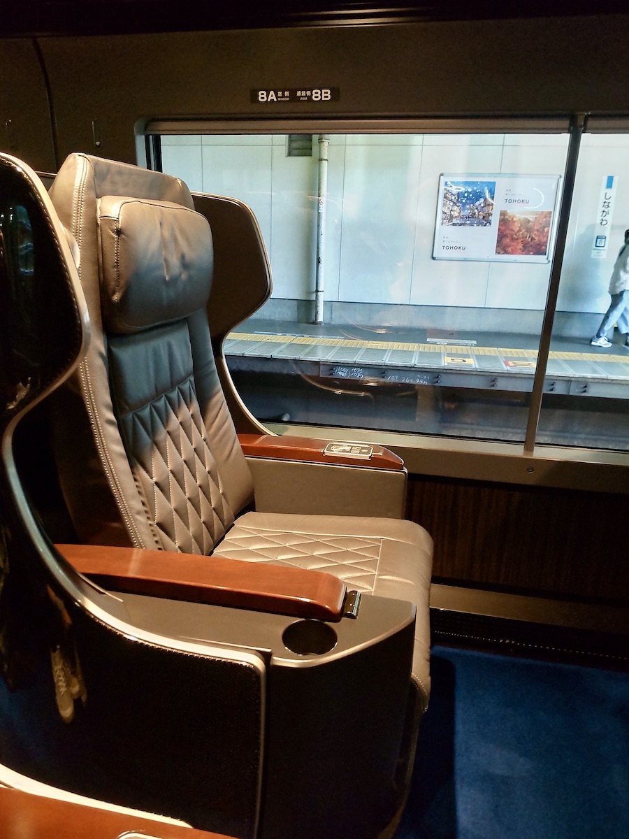 A shiny independent train seat illuminated by a spotlight in a dark cabin