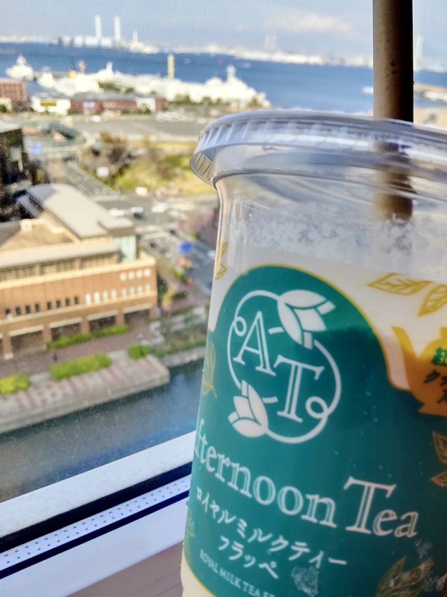 Milk tea frappe in a transparent cup with a harbor view background