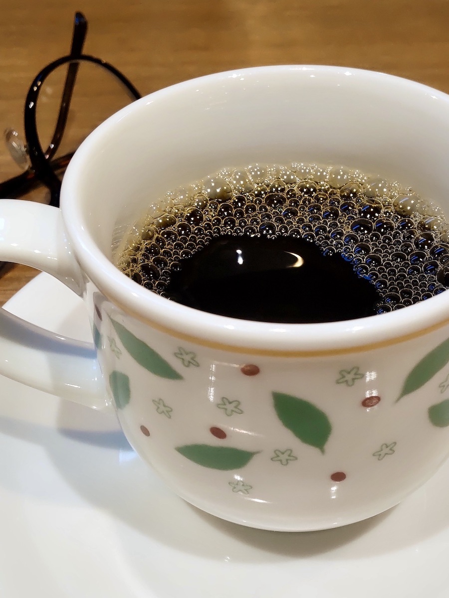 A warm cup of coffee in a white, round-shaped mug