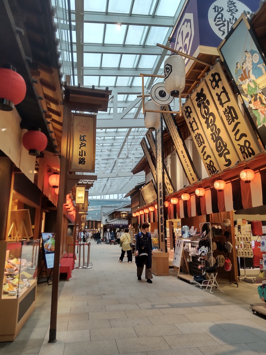 A Japanese-style shopping arcade lined with signs displaying the names of Kabuki actors