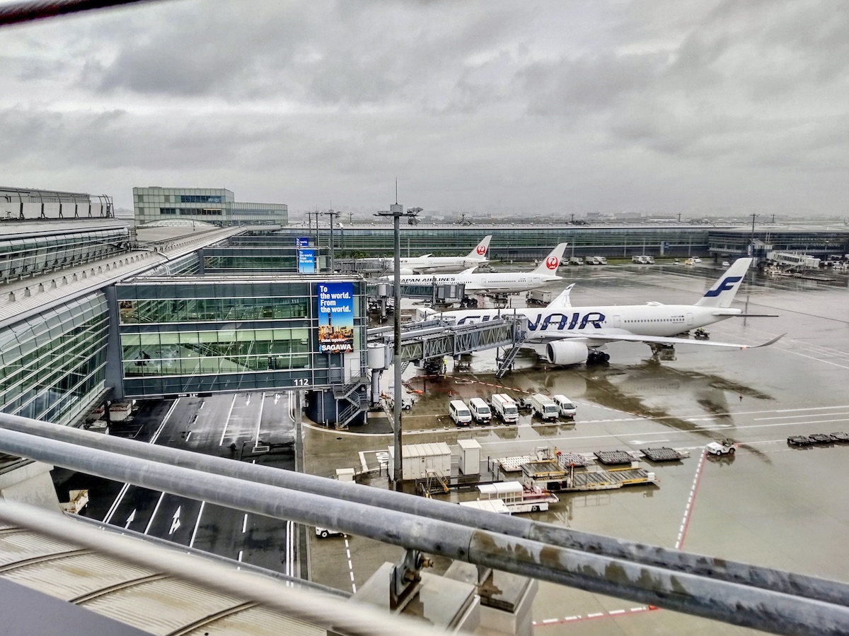JAL and Finnair airplanes parked side by side on the airport apron