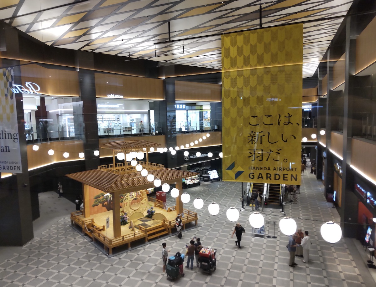 A high-angle view looking down at a traditional Japanese stage located in a central atrium
