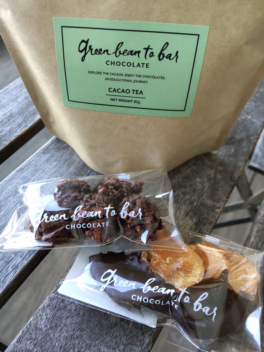 Two types of chocolate sweets placed in front of a brown paper carton