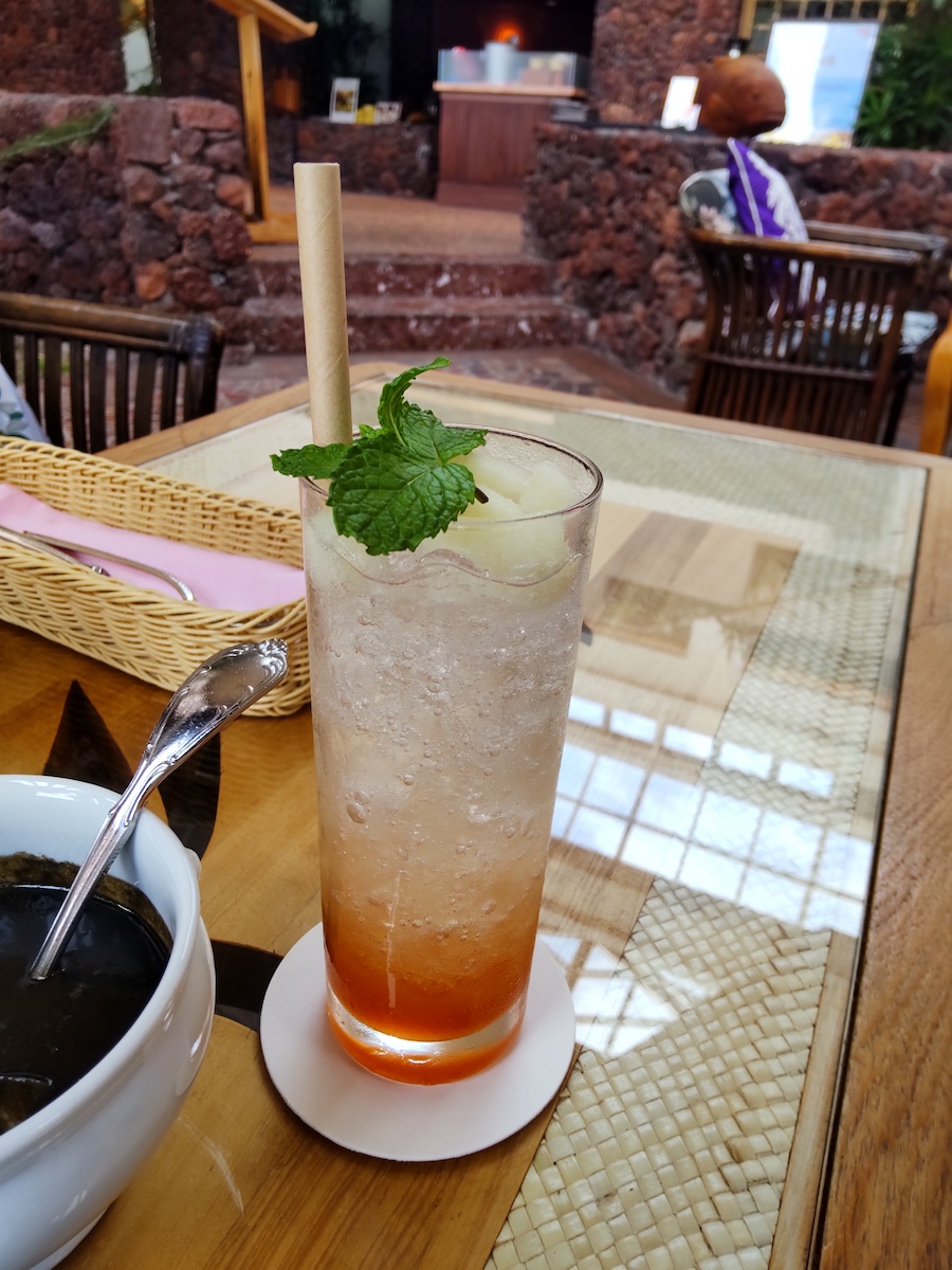 A fizzy soda drink with a beautiful gradient of red syrup