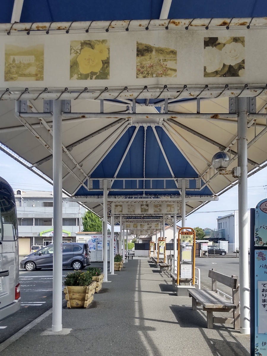 A station bus terminal with a light blue and white roof structure