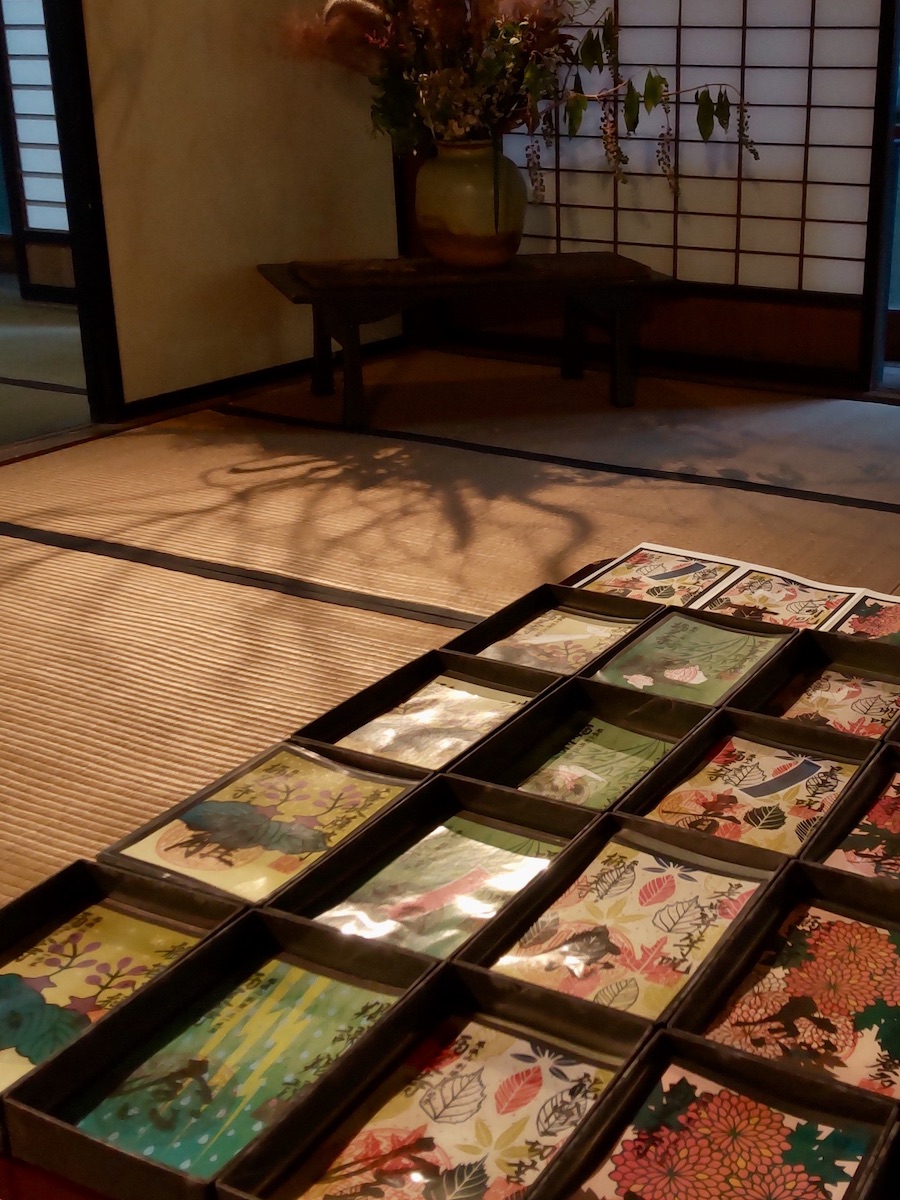 Colorful cards lined up on a table inside a traditional Japanese room