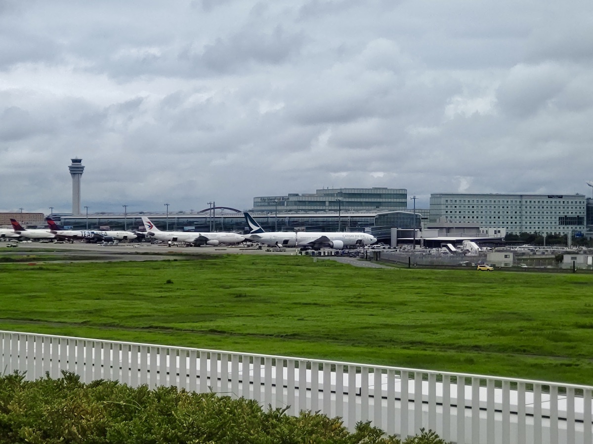A wide view of airplanes parked at Haneda Airport with the control tower