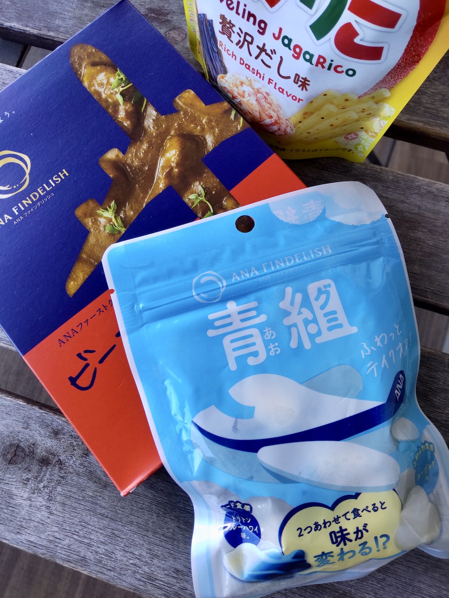A package of ANA branded gummies, beef curry, and Japanese snacks on a table