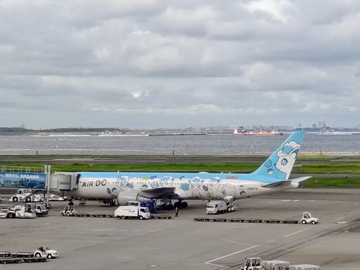 AIR DO Pokémon themed airplane featuring Vulpix parked on the tarmac