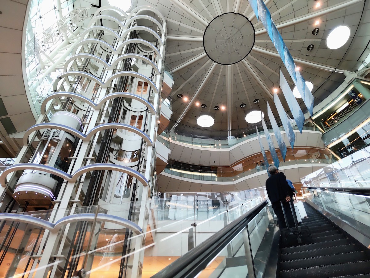 Modern glass elevators and high dome ceiling inside Haneda Airport Terminal 2