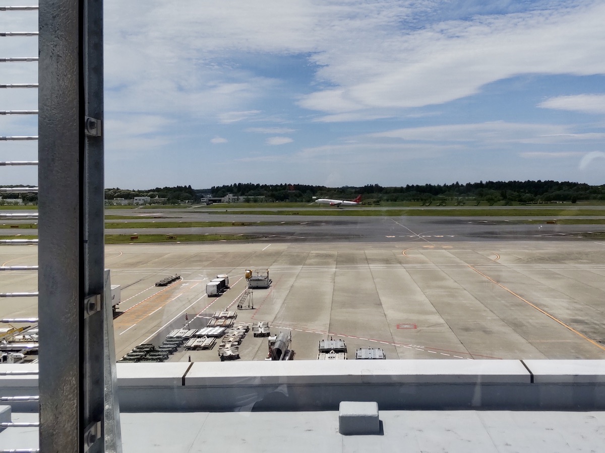 An airplane capturing the exact moment of takeoff on the distant runway