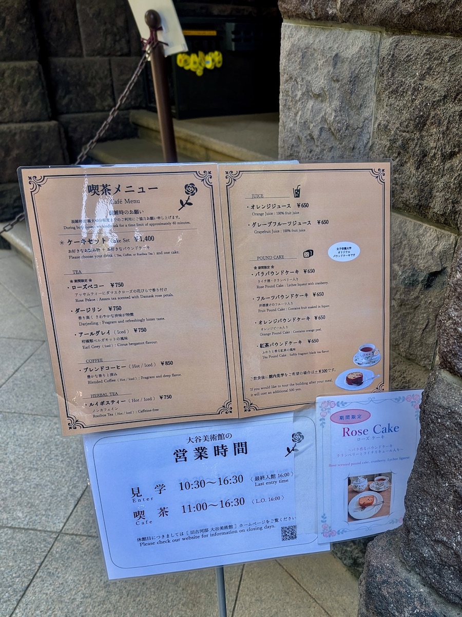 A museum cafe information board showing the menu and operating hours
