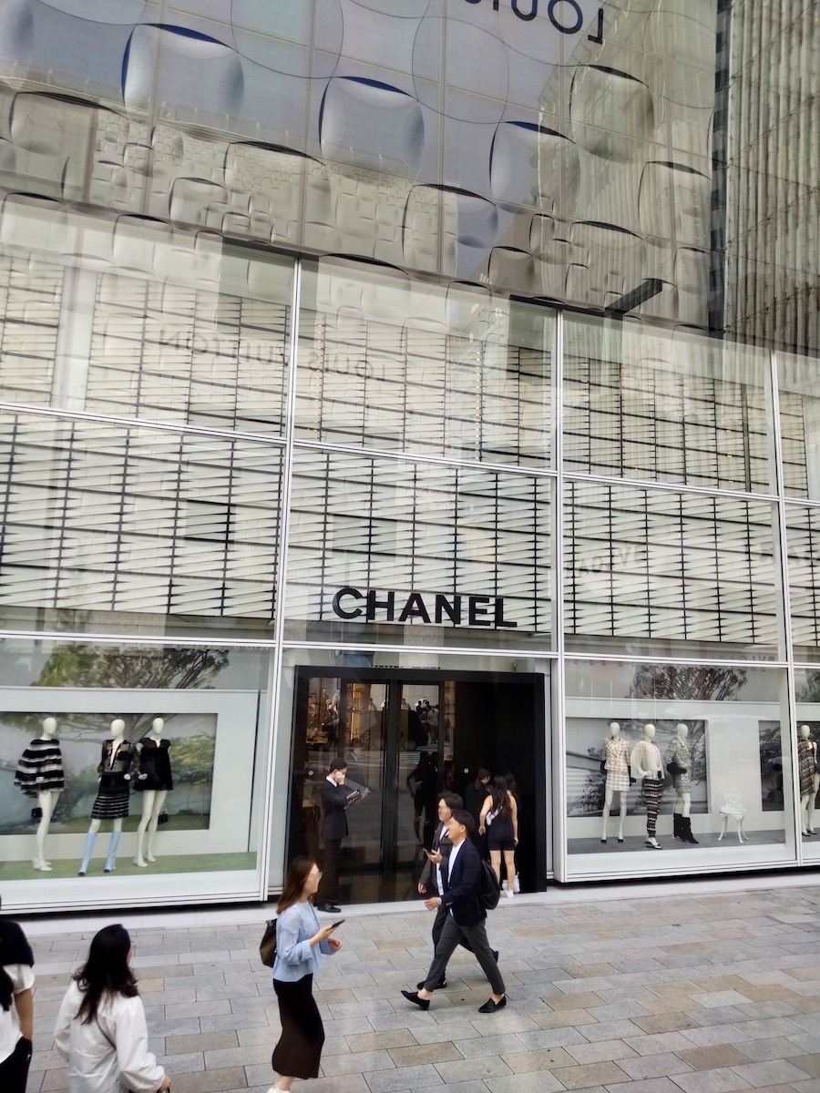 Exterior of a luxury Chanel boutique on a vibrant street in Ginza