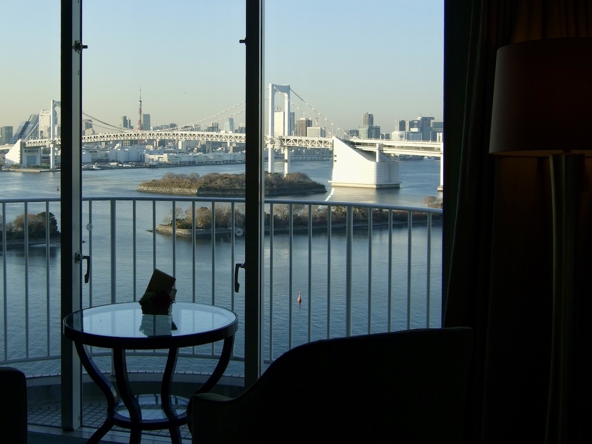 View of Rainbow Bridge and Tokyo Bay seen through a hotel room window