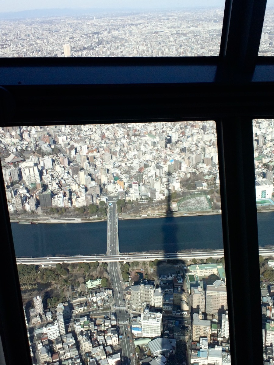 Shadow of Tokyo Skytree cast over the river and city from above