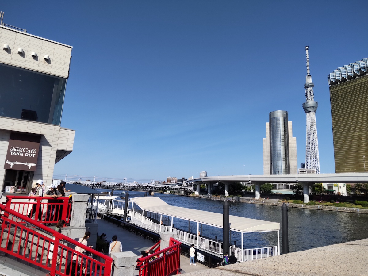 Tokyo Skytree and Sumida River water bus pier under a clear blue sky