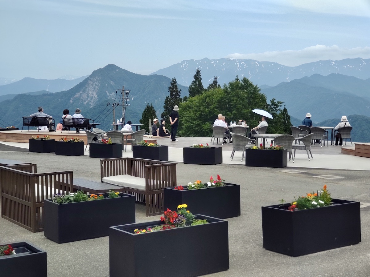 Scenic mountain terrace with comfortable seating areas and vibrant flower boxes