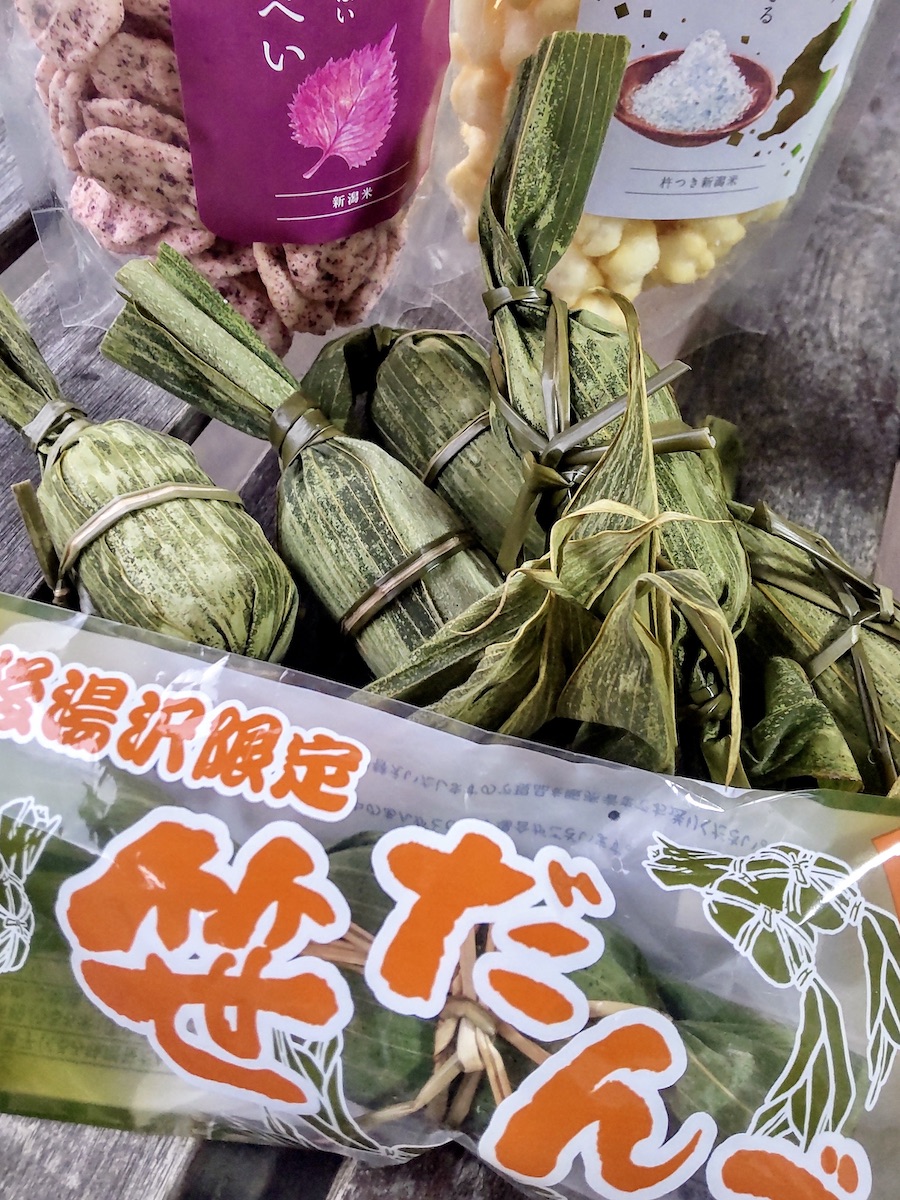 Local Niigata specialty snacks including bamboo leaf wrapped dango and rice crackers