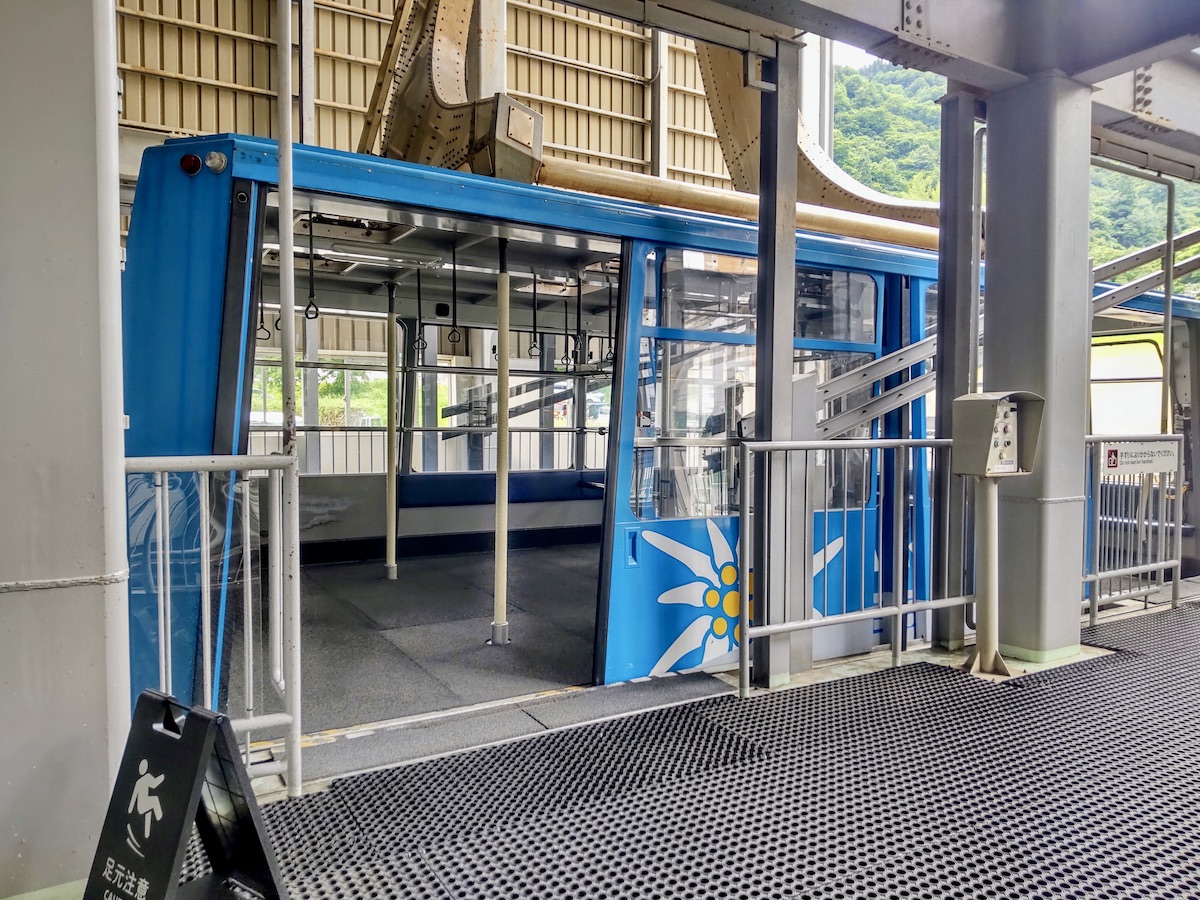 Blue ropeway cabin waiting at the station platform ready for boarding