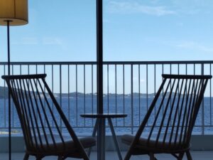 Two natural chairs placed in front of a beautiful ocean view