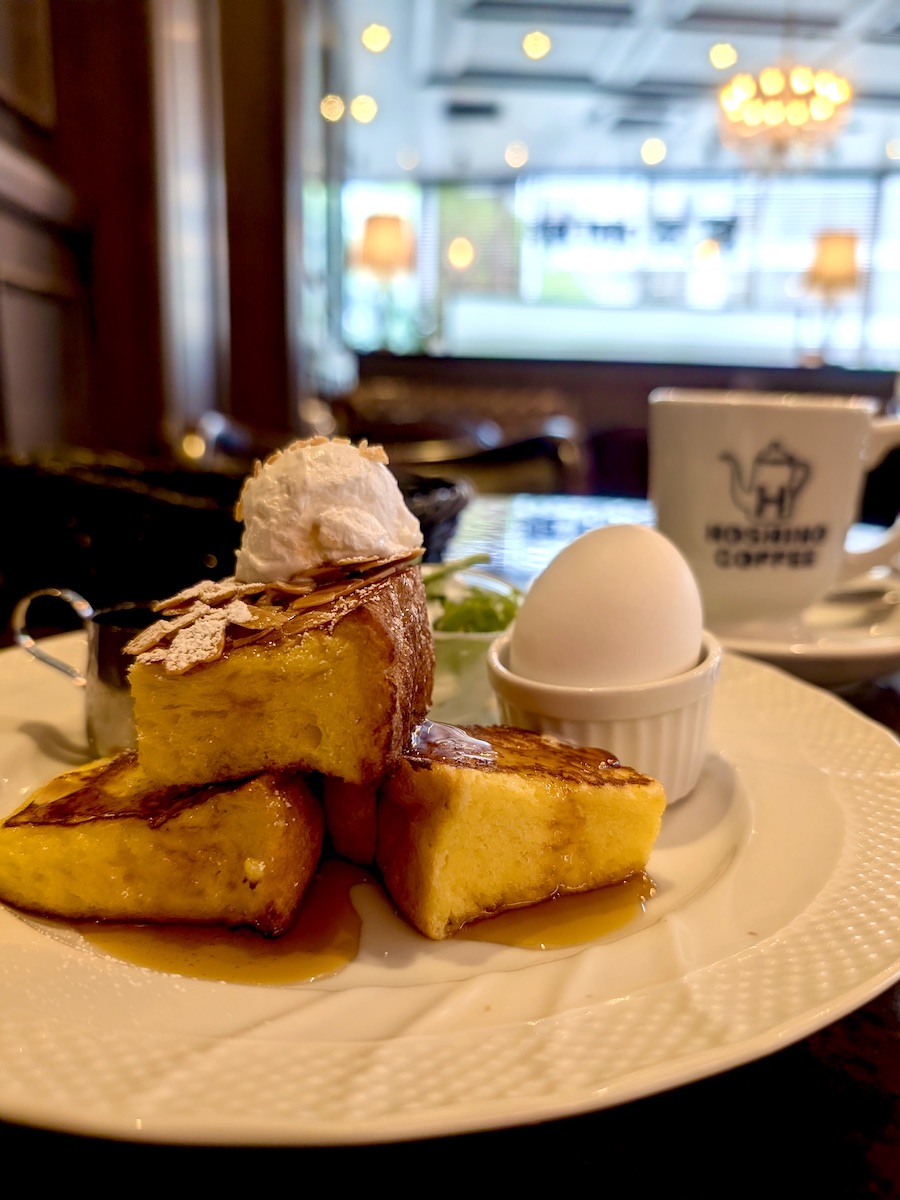 Delicious breakfast French toast topped with cream and syrup in coffee shop