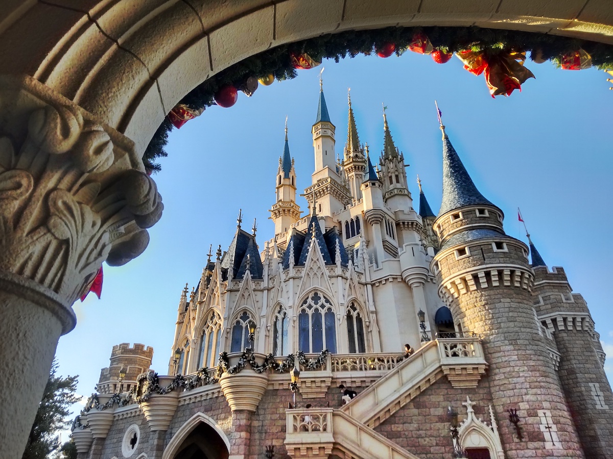 Iconic fairy tale castle with Christmas decorations framed by a stone archway